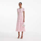 Side view of a woman wearing the Pink Lace Embellished Midi Dress